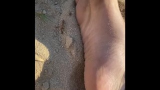 Arching my perfect feet in the sand 