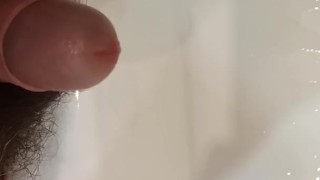 Pees and jerks off in the bathroom. Showing off the dick head.