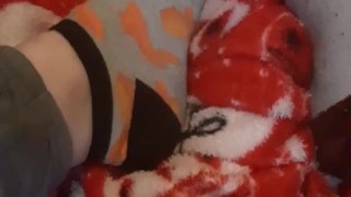 Tiny feet in mix match socks rubbing blanket
