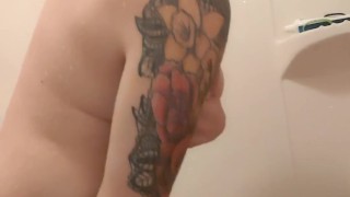 Tatted MILF plays with dildo in the shower