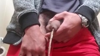 Pissss in toilet wearing red shorts