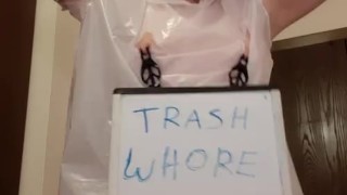 Whore in trash bag drools with humiliation