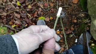 Autumn outdoor self catheter insertion, pee in forest