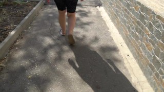 BBW in flip flops walks along the sidewalk while a voyeur peeps on her feet Public foot fetish