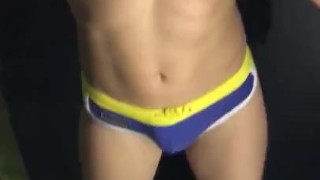 Flexing and showing off in swim trunks