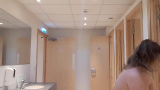Topless girl mopping public washroom floor