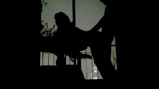 Silhouettes in the Balcony at Night 