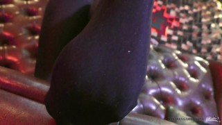 Legs in black opaque pantyhose