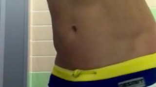 Athletic twink in swim trunks