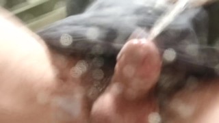 Never-ending pee. View from the bottom of a glass. Balls and uncut POV