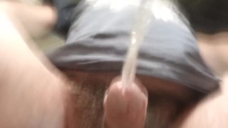 Never-ending pee. View from the bottom of a glass. Balls and uncut POV