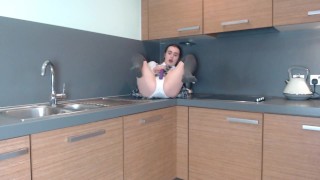 Schoolgirl plays in the kitchen
