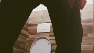A guy with a big cock locked the toilet and masturbated. Long slow cumshot. 