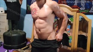 Oiled up stud strokes his big dick on a bosu ball