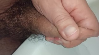 Playing with foreskin and pee. Cock close-up