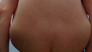 Playing with a big dildo while locked in chastity