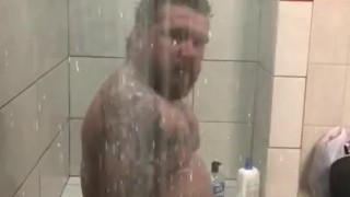 Stud in the shower playing with cock