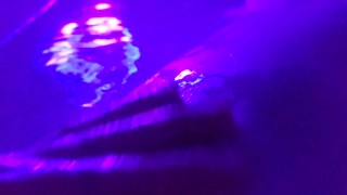 Washing her cheeks in the bath with a blacklight