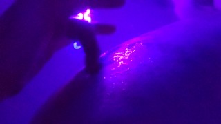 Washing her cheeks in the bath with a blacklight
