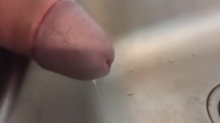 Close up of cock while pissing in the sink