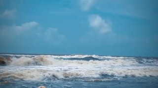 Tik Tok. Beach Voyeur looks on Blonde Teen enjoying Topless in the waves. 