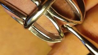 Urethral sounding for locked in chastity cage cock. Close up.