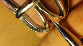 Urethral sounding for locked in chastity cage cock. Close up.