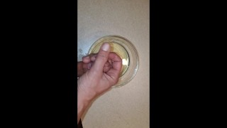 Piss and cum into a bowl. Using piss as lube.