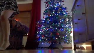 Girl pissing in front of Christmas while family is upstairs