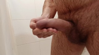 Jerking off gently in the bathroom. Saliva on the dickhead.