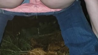 Peeing in the woods along the side of the road
