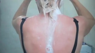 Foamy washing natural blonde hair in wet black dress. Angel Fowler 