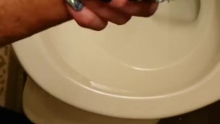 Real amateur girlfriend holds my big white dick and controls my piss while I pee in the toilet 
