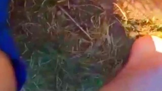 Solo guy rubbing feet in dirt outdoors