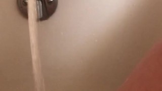 Horny hot thick MILF wiggles hips and uses bath tub faucet to get off in bathtub