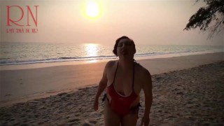 Nice lady at lonely nudist beach. Red swimsuit. Red bikini. Coconut