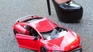 Crush of Red Audi R8 model toy car with Black Pump Stilettos