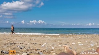 I make him cum while people walk by on the beach