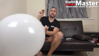 Guy jerks and smokes cigar while blowing, popping and bursting huge balloons PREVIEW