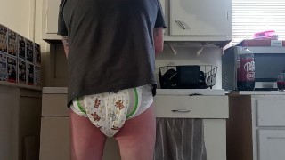 Baby wets diaper while washing dishes