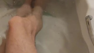 skinny twig strokes his cock and pissed in sink and shows off feet in bathtub