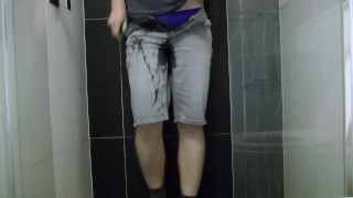 Leaking on a balcony in jean shorts