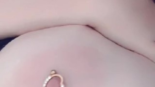 Redhead teases her pierced tits