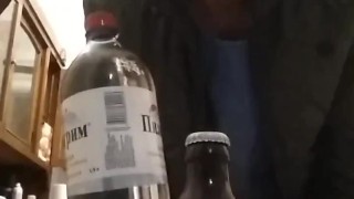 opening a bottle of beer with a bottle of mineral water