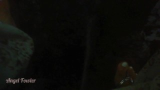 Girl Peeing in darkness into tropical river after sunset - Angel Fowler 
