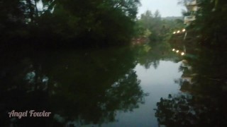Girl Peeing in darkness into tropical river after sunset - Angel Fowler 
