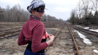 Girl undresses on the train tracks