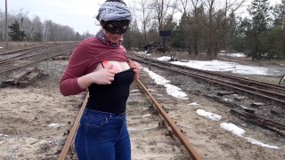 Girl undresses on the train tracks