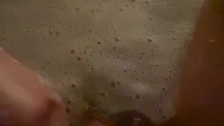 Horny babe plays with her wet pussy in the bath