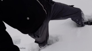 Russian guy walks in the snow near the river, pissing in the snow, he was noticed by a strange guy